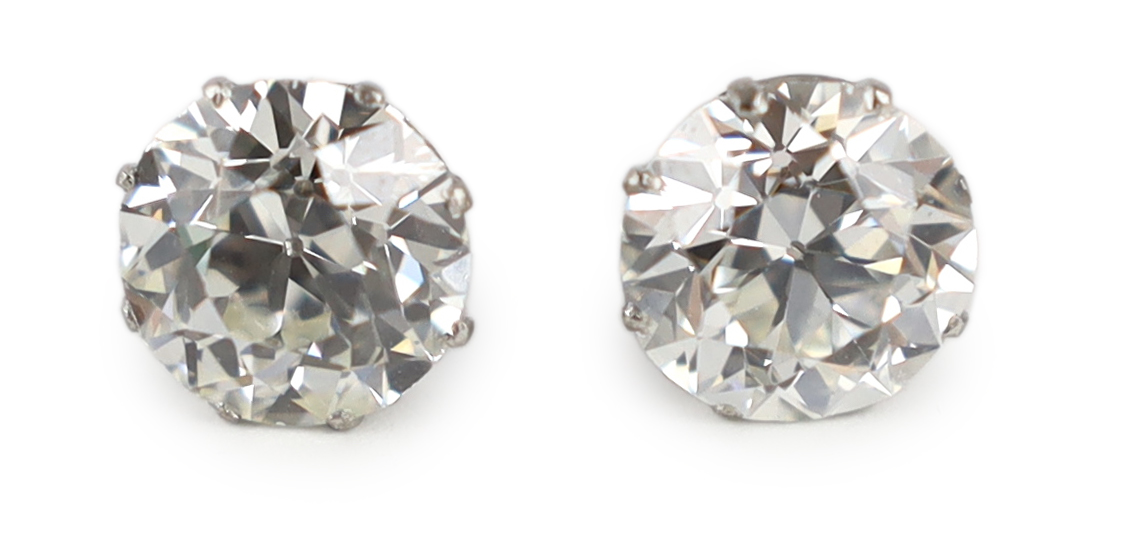 A pair of early 20th century platinum and claw set diamond ear studs